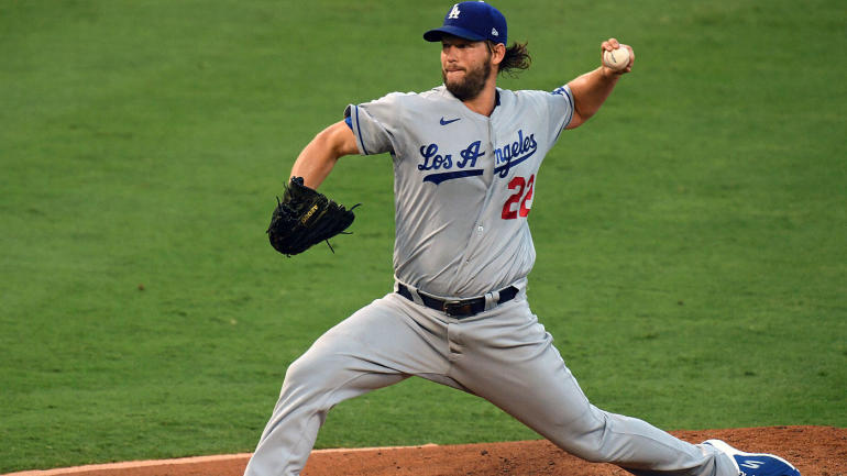 A baseball player throwing a ball
Description automatically generated